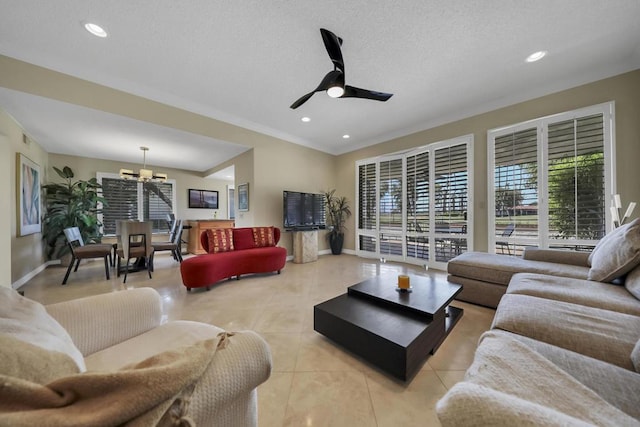 tiled living room featuring ceiling fan with notable chandelier