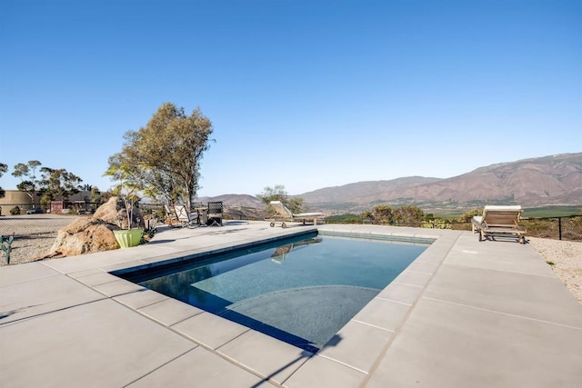 view of pool featuring a patio area and a mountain view