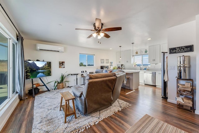 living room featuring a wall unit AC, ceiling fan, dark wood-type flooring, and sink