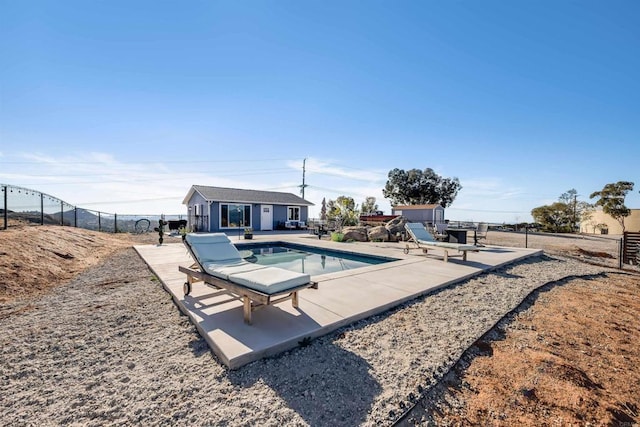 view of pool with an outdoor structure and a patio