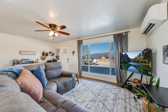 living room featuring ceiling fan, hardwood / wood-style floors, and a wall mounted air conditioner