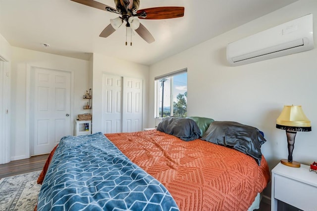 bedroom with ceiling fan, an AC wall unit, and hardwood / wood-style floors