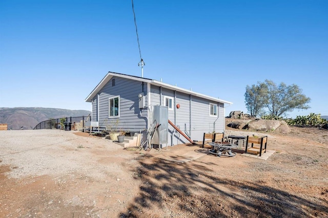 back of property featuring a mountain view