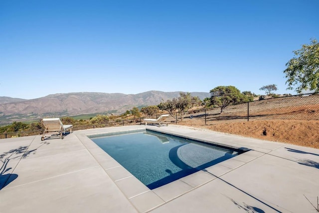 view of pool featuring a patio area and a mountain view