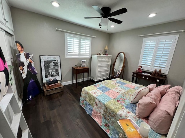 bedroom with ceiling fan and dark wood-type flooring