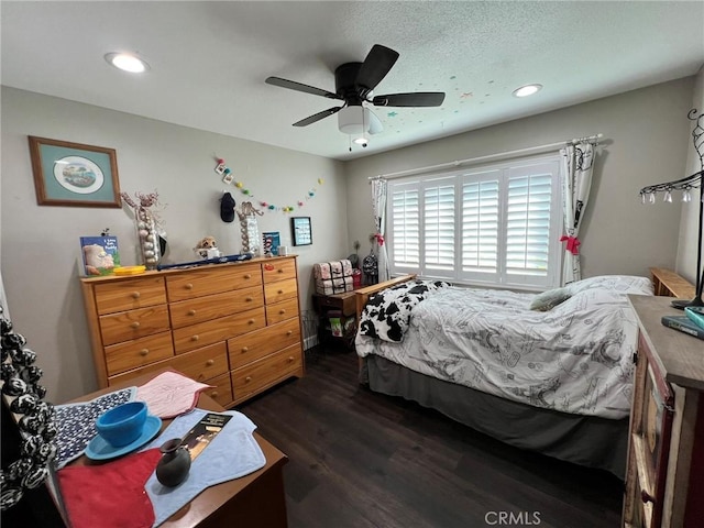 bedroom featuring ceiling fan, a textured ceiling, and dark hardwood / wood-style flooring