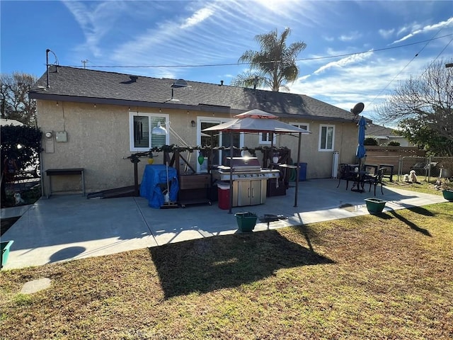 back of house with a patio area and a lawn