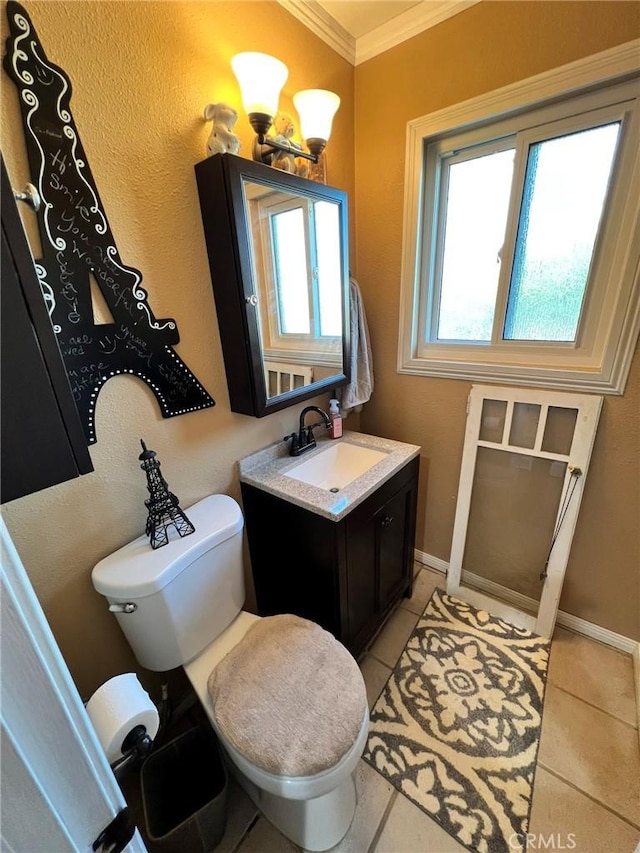 bathroom featuring vanity, plenty of natural light, tile patterned floors, and ornamental molding