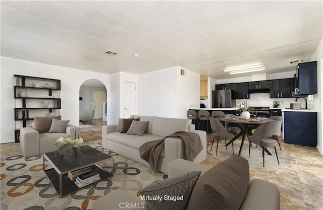 living room featuring light tile patterned floors and sink