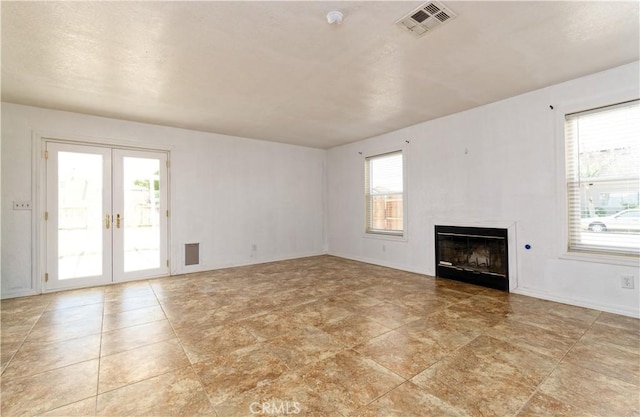 unfurnished living room with french doors