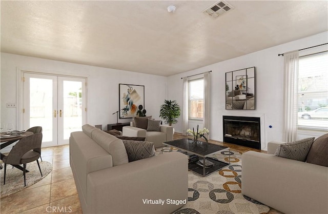 tiled living room featuring french doors