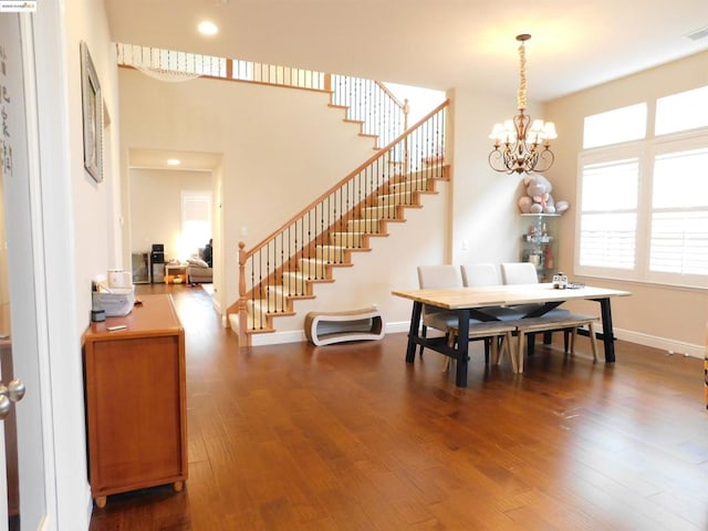 dining room featuring dark hardwood / wood-style flooring and an inviting chandelier