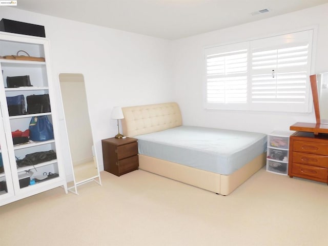 bedroom featuring light colored carpet