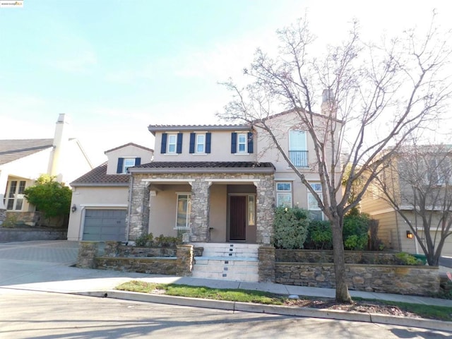 view of front facade featuring a porch and a garage