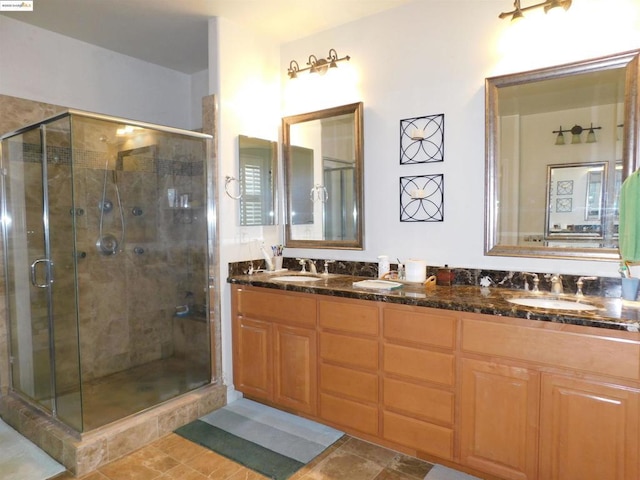 bathroom with walk in shower, vanity, and tile patterned floors