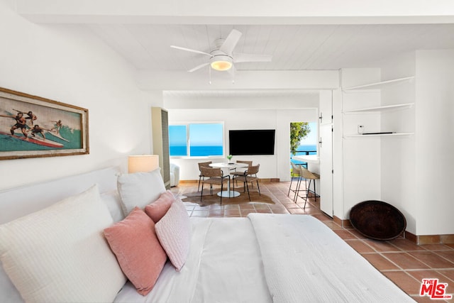 bedroom featuring beam ceiling and tile patterned floors