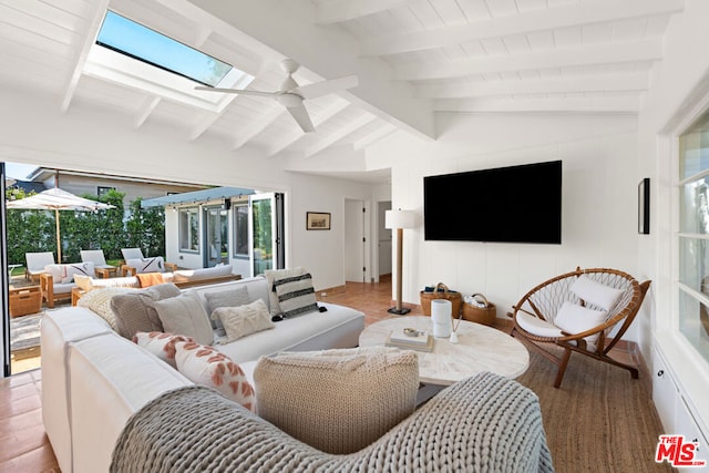 living room with ceiling fan and vaulted ceiling with beams