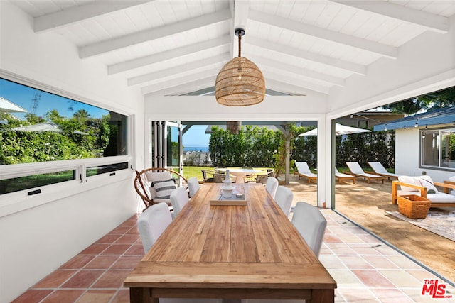 sunroom with plenty of natural light and vaulted ceiling with beams