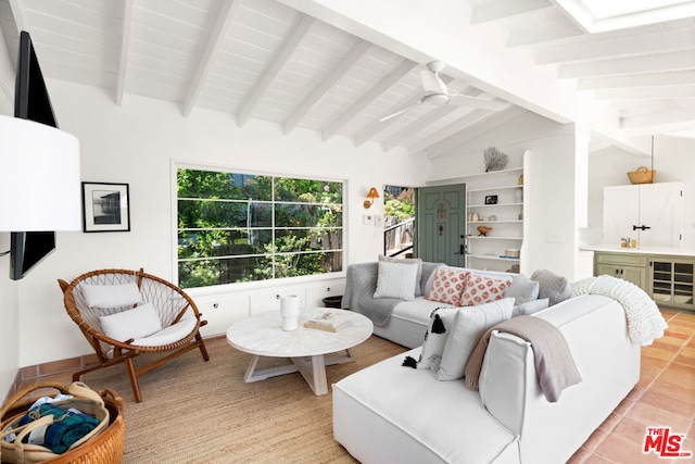 living room featuring ceiling fan and vaulted ceiling with beams