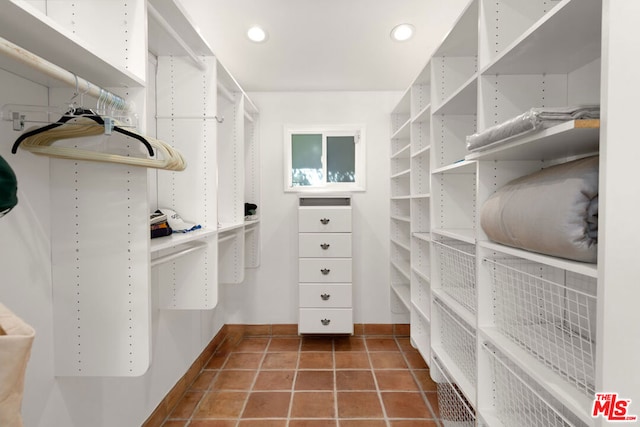 walk in closet featuring dark tile patterned floors