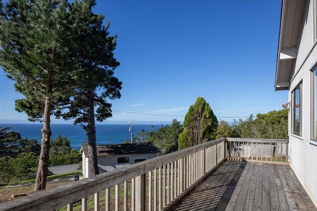 wooden terrace featuring a water view