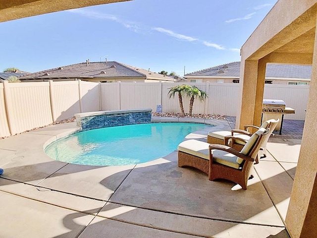 view of swimming pool featuring pool water feature, a patio area, and area for grilling