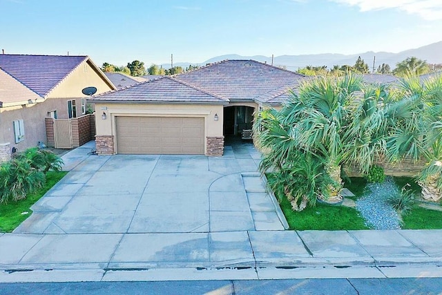 view of front facade with a mountain view and a garage