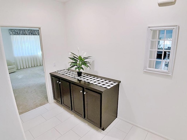 hallway featuring light tile patterned floors