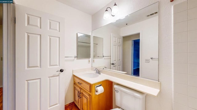 bathroom with toilet and vanity