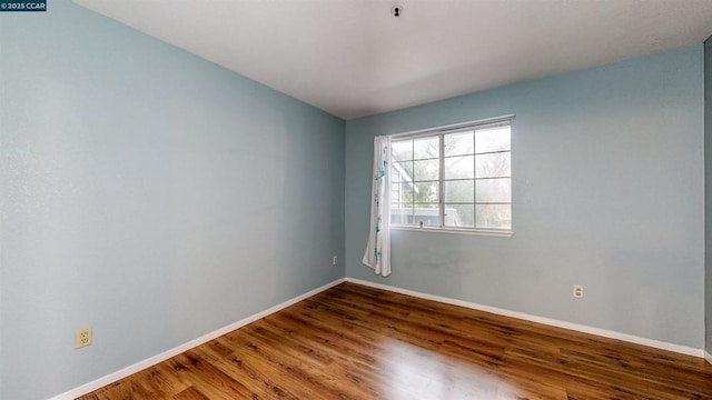 spare room with wood-type flooring