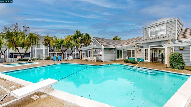 view of pool with a community hot tub and a pergola