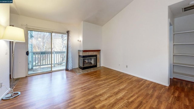 unfurnished living room with a fireplace and wood-type flooring