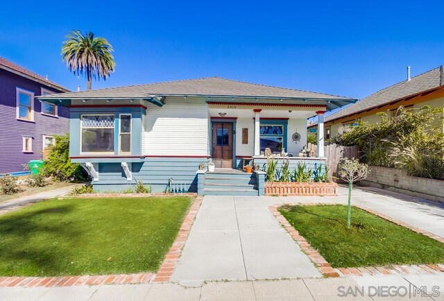 view of front of home with a porch and a front lawn