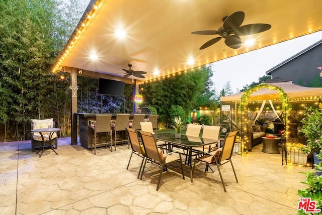 view of patio / terrace with ceiling fan and exterior bar