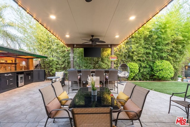 view of patio featuring ceiling fan and wine cooler