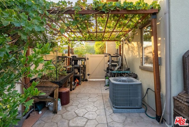 view of patio / terrace featuring central AC unit and a pergola