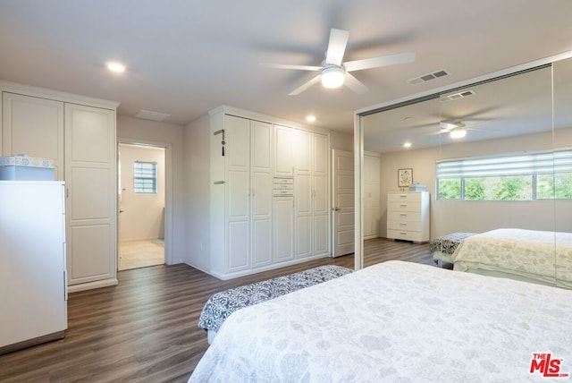 bedroom with dark hardwood / wood-style floors and ceiling fan