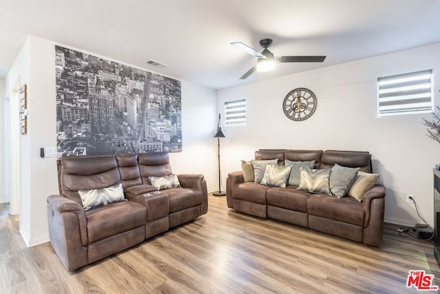 living room with light hardwood / wood-style floors and ceiling fan