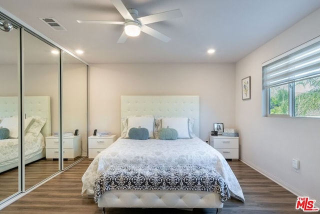 bedroom featuring a closet, ceiling fan, and dark hardwood / wood-style floors