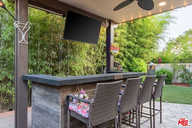 view of patio / terrace with ceiling fan and an outdoor bar