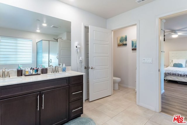 bathroom with vanity, toilet, walk in shower, and tile patterned floors