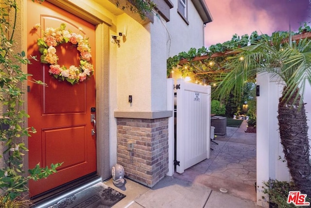 view of exterior entry at dusk