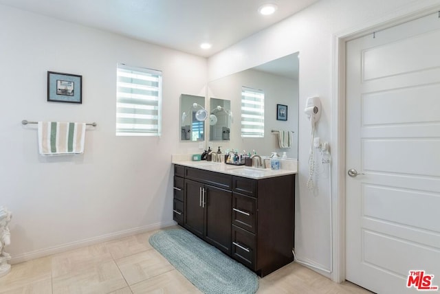 bathroom with tile patterned flooring and vanity