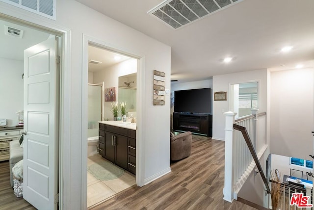 hallway with sink and hardwood / wood-style floors