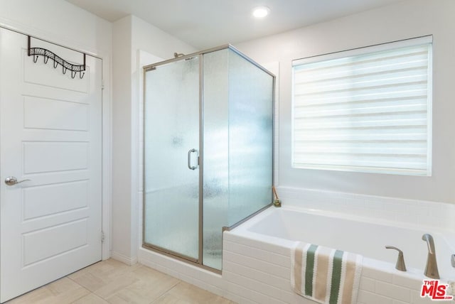 bathroom with tile patterned floors and shower with separate bathtub