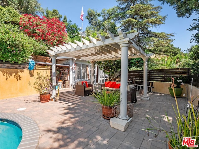 view of patio / terrace with an outdoor living space and a pergola