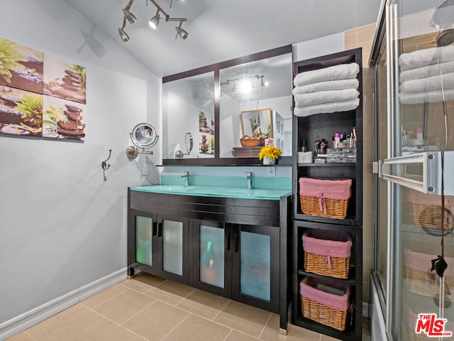 bathroom featuring tile patterned floors, a shower with door, lofted ceiling, and vanity