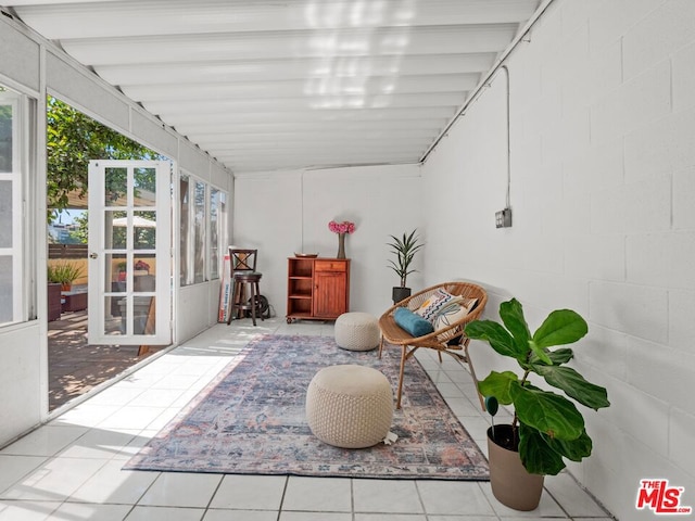 sunroom with lofted ceiling with beams