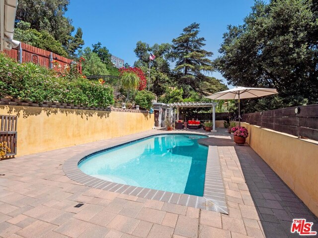 view of pool featuring a patio area and a pergola