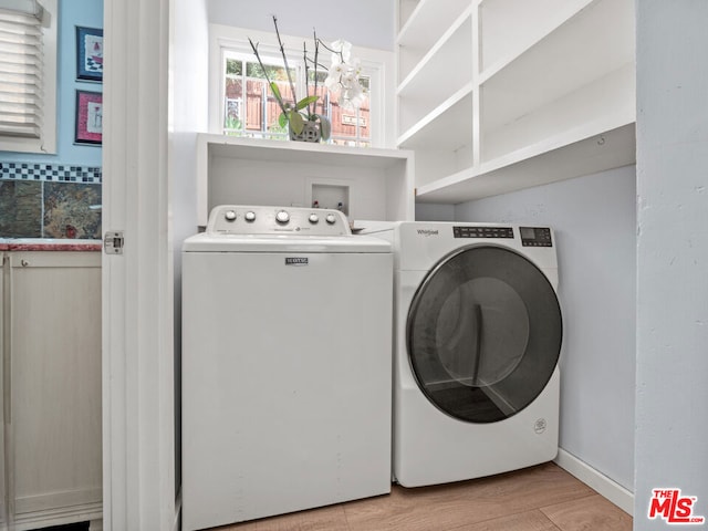 washroom featuring separate washer and dryer and light hardwood / wood-style floors